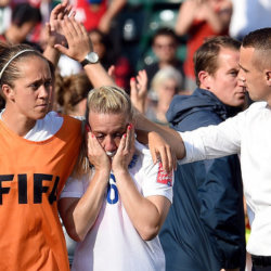 Laura Bassett (C), a defender on England's women's World Cup team, is comforted by England's head coach Mark Sampson (R) and teammate, Josanne Potter (L), afer Basset's own goal in the 90th minute lost the game for England during their semifinal match against Japan in 2015 FIFA Women's World Cup, Edmonton, Canada, July 1, 2015 (Credit: Icon Sportswire/Xinhua/Imago