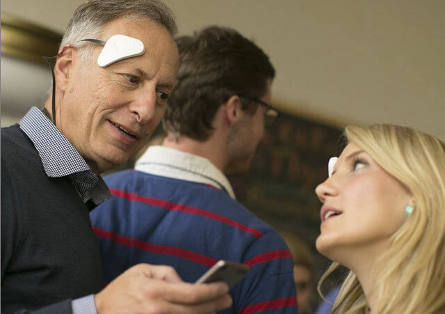 An older man and a younger woman try the Thync neurosignaling device at the Thync Salon in San Francisco, July 2, 2015 (Credit: Thync via Instagram)