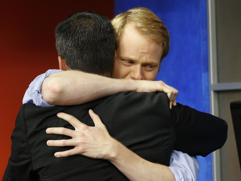 WDBJ-TV7 anchor Chris Hurst, right, hugs meteorologist Leo Hirsbrunner during the early morning newscast at WDBJ-TV7 after Hurst's fiance Alison Parker was killed during a live broadcast, Roanoke, Virginia, August 27, 2015 (Credit: AP Photo/Steve Helber)