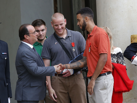 French President Francois Hollande and a bevy of officials are presenting the Americans with the prestigious Legion of Honor on Monday. The three American travelers say they relied on gut instinct and a close bond forged over years of friendship as they took down a heavily armed man on a passenger train speeding through Belgium. (Credit: AP Photo/Michel Euler)