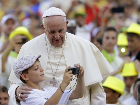 Pope Francis is showed his portrait taken by a boy as he arrives in St. Peter's Square at the Vatican for an audience with with Altar boys and girls, August 4, 2015 (Credit: AP Photo/Gregorio Borgia)