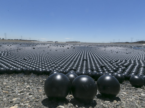 Over 90 million 4-inch-diameter plastic balls, called shade balls, cover the Los Angeles Reservoir to block sunlight from penetrating the 175-acre surface of the reservoir, preventing chemical reactions that can cause algae blooms and other problems, Los Angeles, California, August 12, 2015 (Credit: AP Photo/Damian Dovarganes)