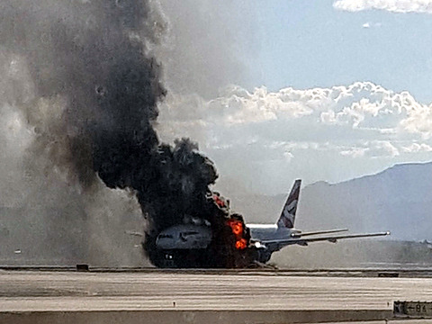 An engine on the British Airways plane caught fire before takeoff, forcing passengers to escape on emergency slides, at McCarren International Airport, September 8, 2015 (Credit: AP Photo/Eric Hays)
