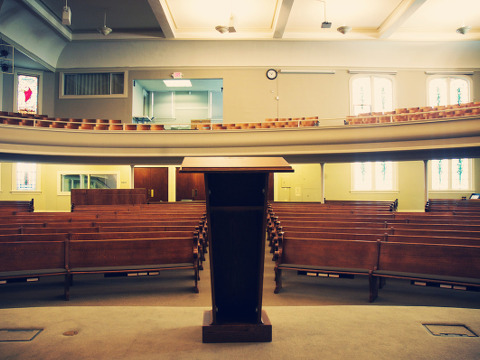 Rows of church pews, podium, altar, empty church (Credit: Ekko via Lightstock)