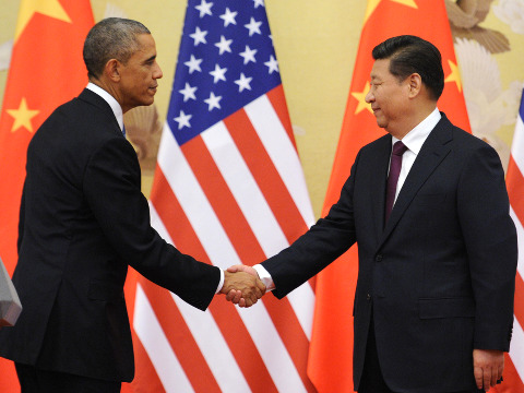 U. S. President Barack Obama (L) and Chinese President Xi Jinping shake hands after a joint press conference at the Great Hall of the People in Beijing, China, November 12, 2014 (Credit: AP Images/Yomiuri Shimbun)