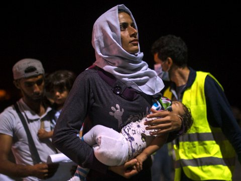 A Syrian family board a ferry traveling to Athens, at the port of Lesbos Island, Greece, an island of 100,000 residents that has been transformed by the sudden new population of some 20,000 refugees and migrants, mostly from Syria, Iraq and Afghanistan, September 7, 2015 (Credit: AP Photo/Santi Palacios)