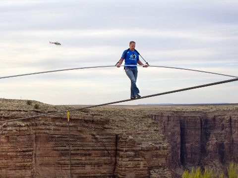 Nik Wallenda nears the completion of his 1400 foot walk across the Grand Canyon for Discovery Channel's Skywire Live With Nik Wallenda, Grand Canyon, California, June 23, 2013 (Credit: AP Images/Tiffany Brown)