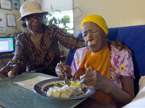 Lois Judge, left, helps her aunt Susannah Mushatt Jones, 115, during breakfast in Jones' room at the Vandalia Avenue Houses, in the Brooklyn borough of New York; Jones and Emma Morano, of Verbania, Italy, who is also 115, are believed to be the last two people in the world with birthdates in the 1800s; June 22, 2015 (Credit: AP Photo/Richard Drew)