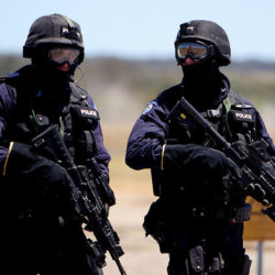 Two West Australian TRG officers wander toward their 4WD after their demonstration of rappelling from the Police Helicopter, November 19, 2005 (Credit: Devar via Fotolia)