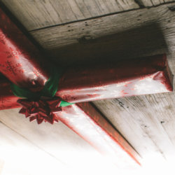 Cross wrapped in Christmas wrapping paper (Credit: Pearl via Lightstock)
