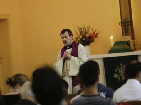 Pastor Gottfried Martens prays with people from Iran and Afghanistan, who are converting to Christianity in drives, during a service to baptize them in the Trinity Church in Berlin, Germany, August 30, 2015 (Credit: AP Photo/Markus Schreiber)