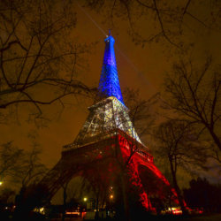 The Eiffel Tower illuminated in the French colors in honor of the victims of the attacks on Friday in Paris, November 16, 2015 (Credit: AP Photo/Daniel Ochoa de Olza)