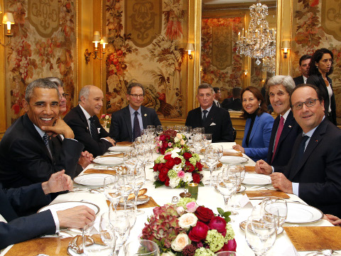 President Barack Obama, left, sits with French President Francois Hollande, right, as they have dinner at the Ambroisie restaurant in Paris, France, with Secretary of State John Kerry, 2nd right, French Minister for Ecology, Sustainable Development and Energy Segolene Royal, 3rd right, and French Foreign Minister, Laurent Fabius, 3rd left, during a two-day visit to France as part of the COP21, United Nations Climate Change, conference, November 30, 2015 (Credit: AP Photo/Thibault Camus)