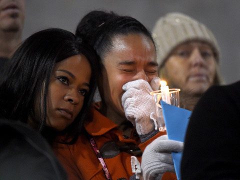 A woman cries during a candlelight vigil at San Manuel Stadium for shooting victims of husband and wife terrorists who opened fire on a holiday banquet, killing multiple people, San Bernardino, California, December 3, 2015 (Credit: AP Photo/Mark J. Terrill)