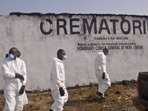 Health workers prepare to collect the ashes of people that died due to the Ebola virus at a crematorium on the outskirts of Monrovia, Liberia, March 7, 2015 (Credit: AP Photo/ Abbas Dulleh)