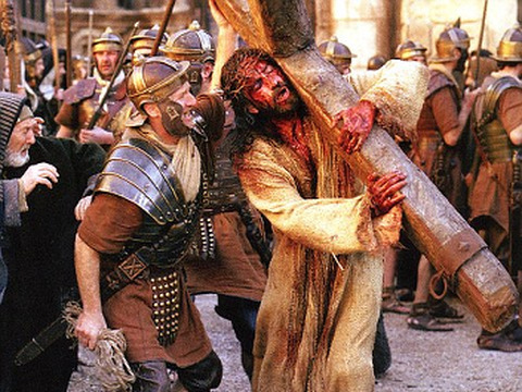 'The Passion of the Christ' with Jesus potrayed by Jim Caviezel being mocked by a Roman soldier while carrying the cross (Icon Pictures)