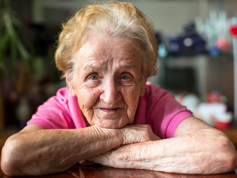Closeup portrait of happy elderly woman. (Credit: De Visu via Fotolia)