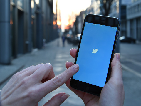 Britta Pedersen launching the Twitter app on her iPhone 6 on the city streets of Berlin, March 20, 2015 (Credit: AP Images/Britta Pedersen)