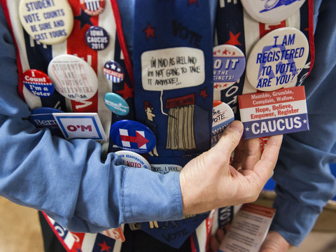 John Olsen, who is commonly known as Dr. Vote, from Ankeny, shows off various caucus pins on his vest at an Ankeny Area Democrats event at the United Auto Workers Local 450 union in Des Moines, Iowa, on Thursday, Jan. 14, 2016. (Credit: Al Drago/AP Images)
