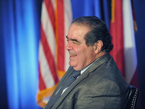 U.S. Supreme Court Justice Antonin Scalia smiles before speaking at a constitutional law symposium where he delivered a talk called “Interpreting the Constitution: A View From the High Court,
