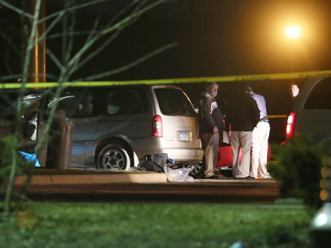 Police investigate the scene early Sunday, Feb. 21, 2016, where people were shot in vehicles outside a Cracker Barrel restaurant in Kalamazoo, Mich. A man drove around Kalamazoo fatally shooting several people at multiple locations Saturday, police said. Authorities identified the shooter as Jason Dalton. (Mark Bugnaski/Kalamazoo Gazette-MLive Media Group via AP)