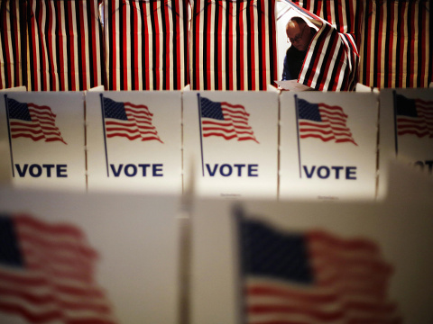 Jim Smith steps out of a voting booth after marking his ballot at a polling site for the New Hampshire primary, Tuesday, Feb. 9, 2016, in Nashua, N.H. (AP Photo/David Goldman)