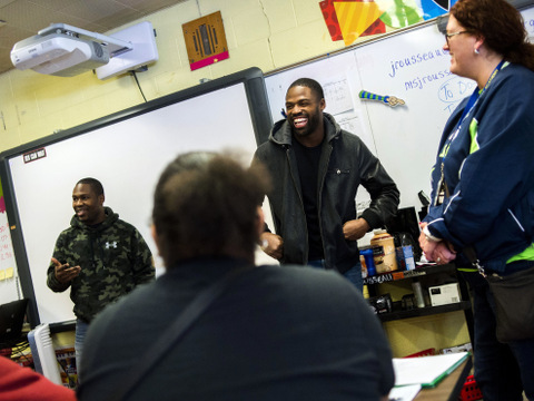 NFL players Justin Forsett, running back for the Baltimore Ravens, and Torrey Smith, wide receiver for the San Francisco 49ers, listen to Flint Southwestern students as they understand their perspective on the city's water crisis on Wednesday, Feb. 10, 2016, at Flint Southwestern Classical Academy in Flint, Mich.(Jake May/The Flint Journal-MLive.com via AP)