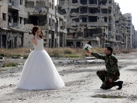 Newlywed Syrian couple Nada Merhi, 18, and Hassan Youssef, 27, pose for a wedding picture amid heavily damaged buildings in the war-ravaged city of Homs on Feb. 5. (Joseph Eid/Agence France-Presse)