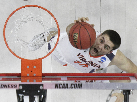 Virginia center Mike Tobey (10) grabs a rebound as Hampton guard Quinton Chievous (3) looks on during the second half of a first-round men's college basketball game in the NCAA Tournament, Thursday, March 17, 2016, in Raleigh, N.C. Virginia won 81-45. (AP Photo/Gerry Broome)