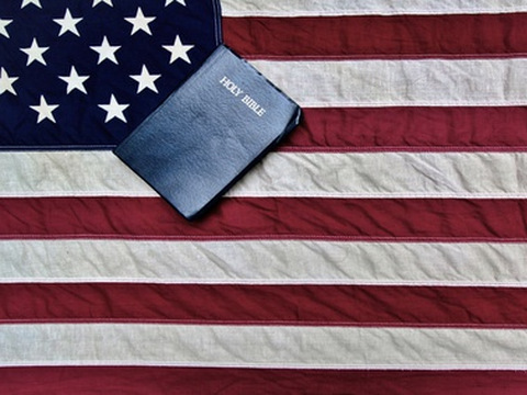 American Flag And Bible. The United States flag and a King James Bible. (Ehrlif via Fotolia)