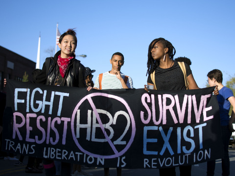 Mitch Xia, left, rallies with other organizers during a march on Franklin Street against N.C. House Bill 2 in Chapel Hill, N.C. on March 29, 2016. The new state law requires transgender people to use the restroom of their biological gender, not the gender with which they identify. (Whitney Keller/The Herald-Sun via AP)