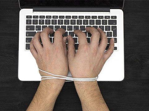 Hands of man addicted to computer, internet slave