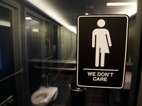 In this photo taken Thursday, May 12, 2016, signage is seen outside a restroom at 21c Museum Hotel in Durham, N.C. North Carolina is in a legal battle over a state law that requires transgender people to use the public restroom matching the sex on their birth certificate. The ADA-compliant bathroom signs were designed by artist Peregrine Honig. (AP Photo/Gerry Broome)