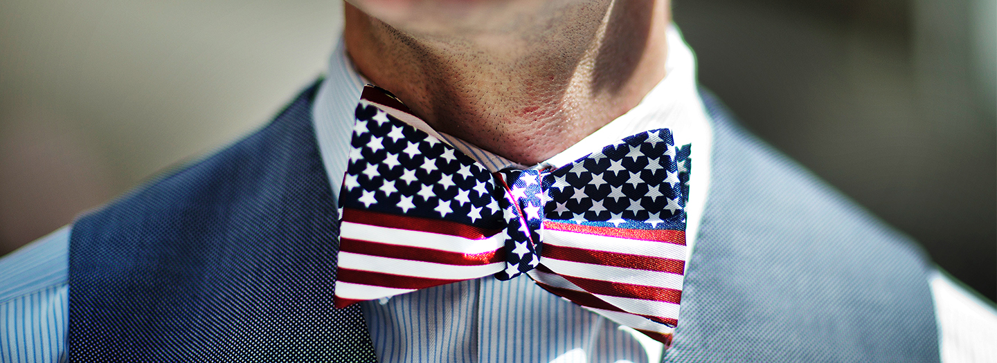 Nick Church, of England, wears an American flag themed bow tie before taking his Oath of Allegiance at a naturalization ceremony Friday, July 1, 2016, in Atlanta. Nineteen new Americans took their oath as United States Citizens in a ceremony at City Hall ahead of the July 4th holiday Friday.