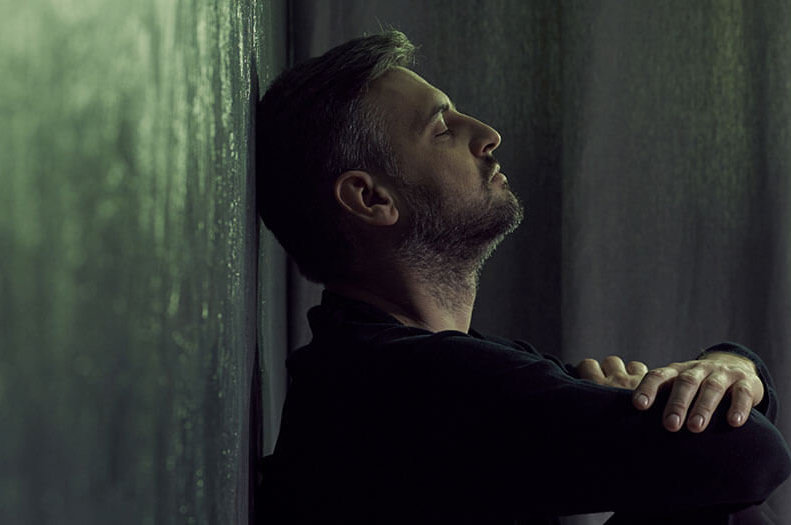 A man sits with his back and head against a wall, arms crossed, suggestive of dealing with anxiety, stress, or depression. ©Photographee.eu/stock.adobe.com. Unfortunately, many people in a similar position may be asking themselves, "What does the Bible say about suicide?"