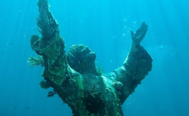 Sigmund Freud dangling by an arm and Jesus at the bottom of the sea: Strange sculptures and the urgency of faith today