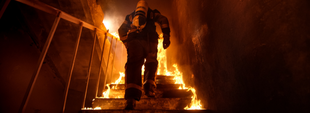 Former football player dove and caught a child dropped from a burning building