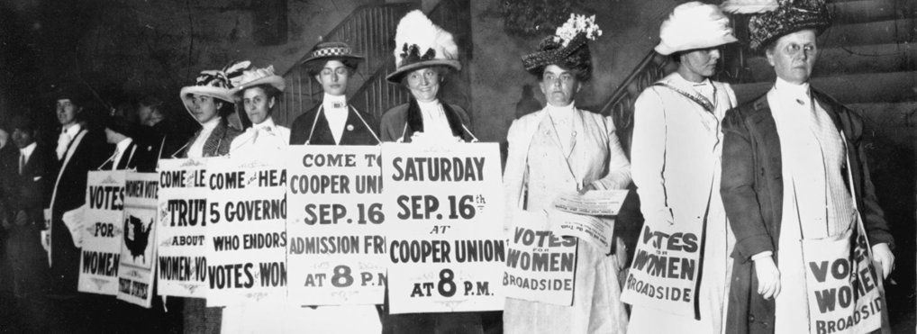A line of women rally for women's suffrage and advertise a free rally discussing women's right to vote in New York, in Sept. 1916.
