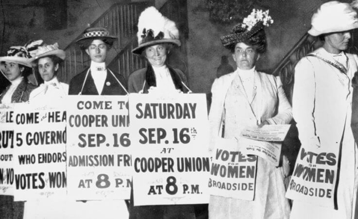 A line of women rally for women's suffrage and advertise a free rally discussing women's right to vote in New York, in Sept. 1916.