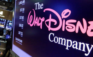The Walt Disney Co. logo appears on a screen above the floor of the New York Stock Exchange