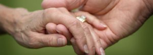 Closeup of a married elderly couple holding hands