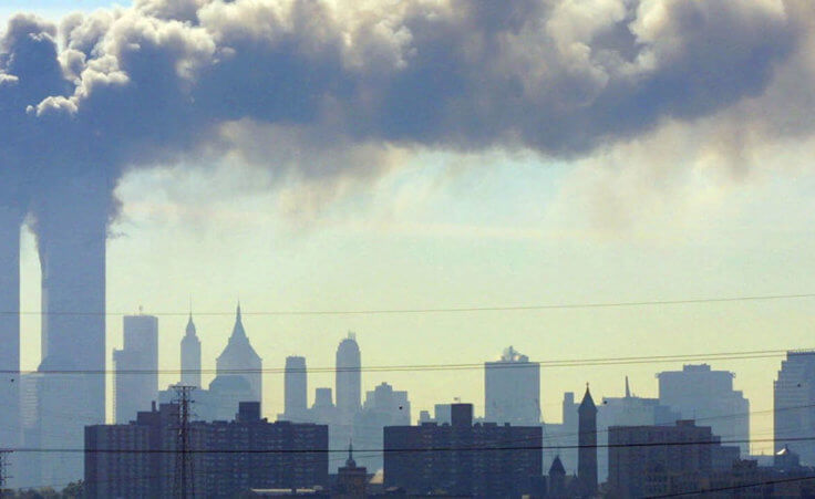 As seen from the New Jersey Turnpike near Kearny, N.J., smoke billows from the twin towers of the World Trade Center in New York
