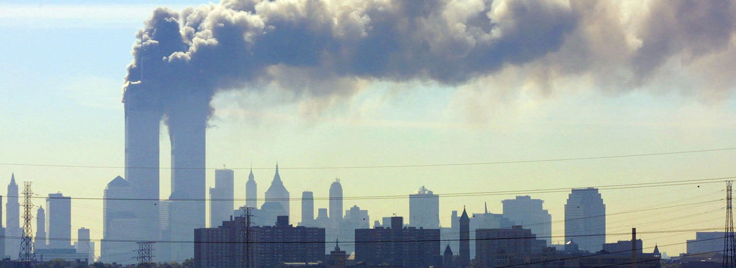 As seen from the New Jersey Turnpike near Kearny, N.J., smoke billows from the twin towers of the World Trade Center in New York