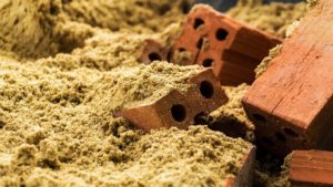 Bricks and sand to illustrate the article Loving God and people in an uncivil world. By KION/stock.adobe.com