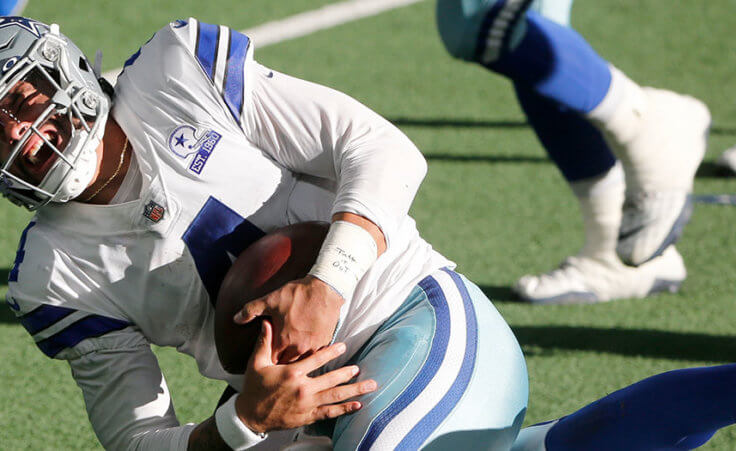 Dallas Cowboys quarterback Dak Prescott (4) is tackled by New York Giants cornerback Logan Ryan, rear, in the second half of an NFL football game in Arlington, Texas, Sunday, Oct. 11, 2020.