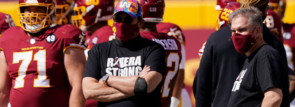 Washington Football Team head coach Ron Rivera watches teams warm up before the first half of an NFL football game between the Washington Football Team and the Baltimore Ravens, Sunday, Oct. 4, 2020, in Landover, Md.
