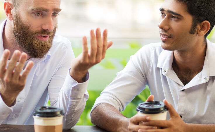 Two men have coffee