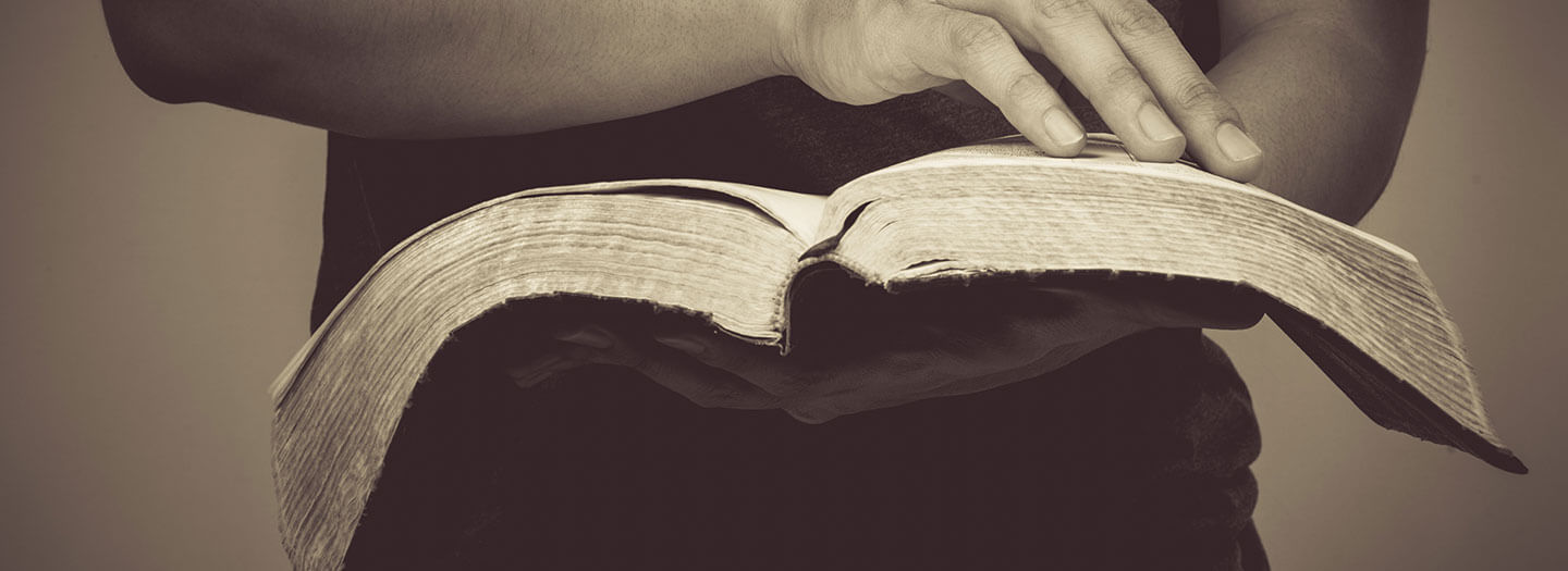 A man holds an open Bible