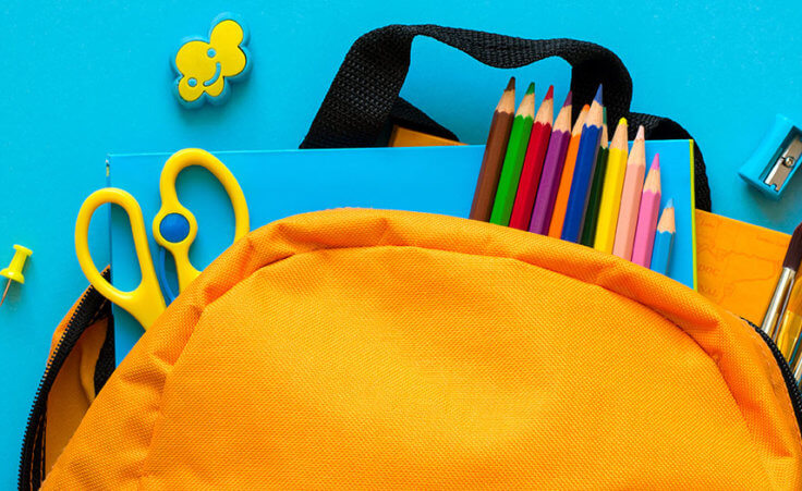 A yellow backpack contains school supplies