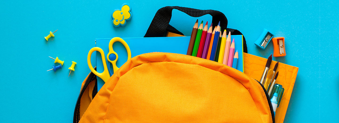 A yellow backpack contains school supplies